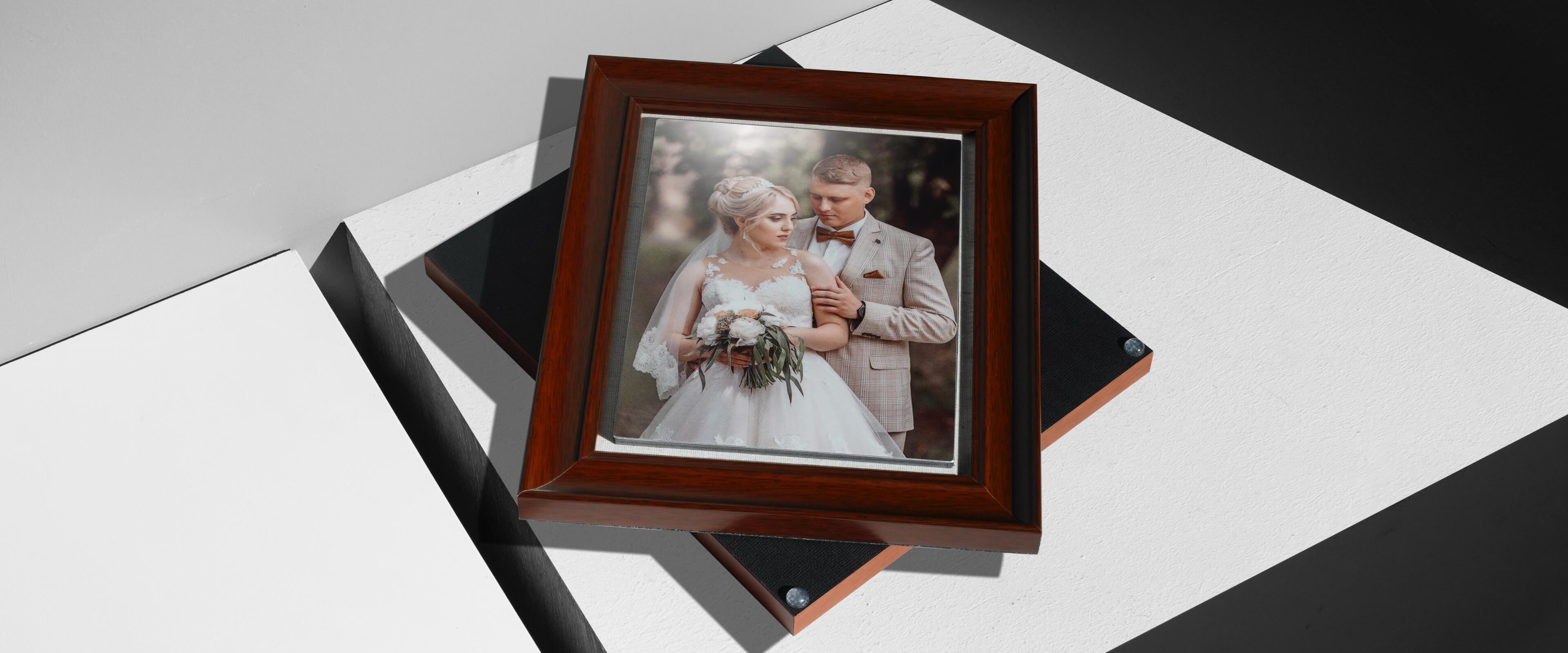 framed metal print stacked on top of another framed metal print showing wedding couple