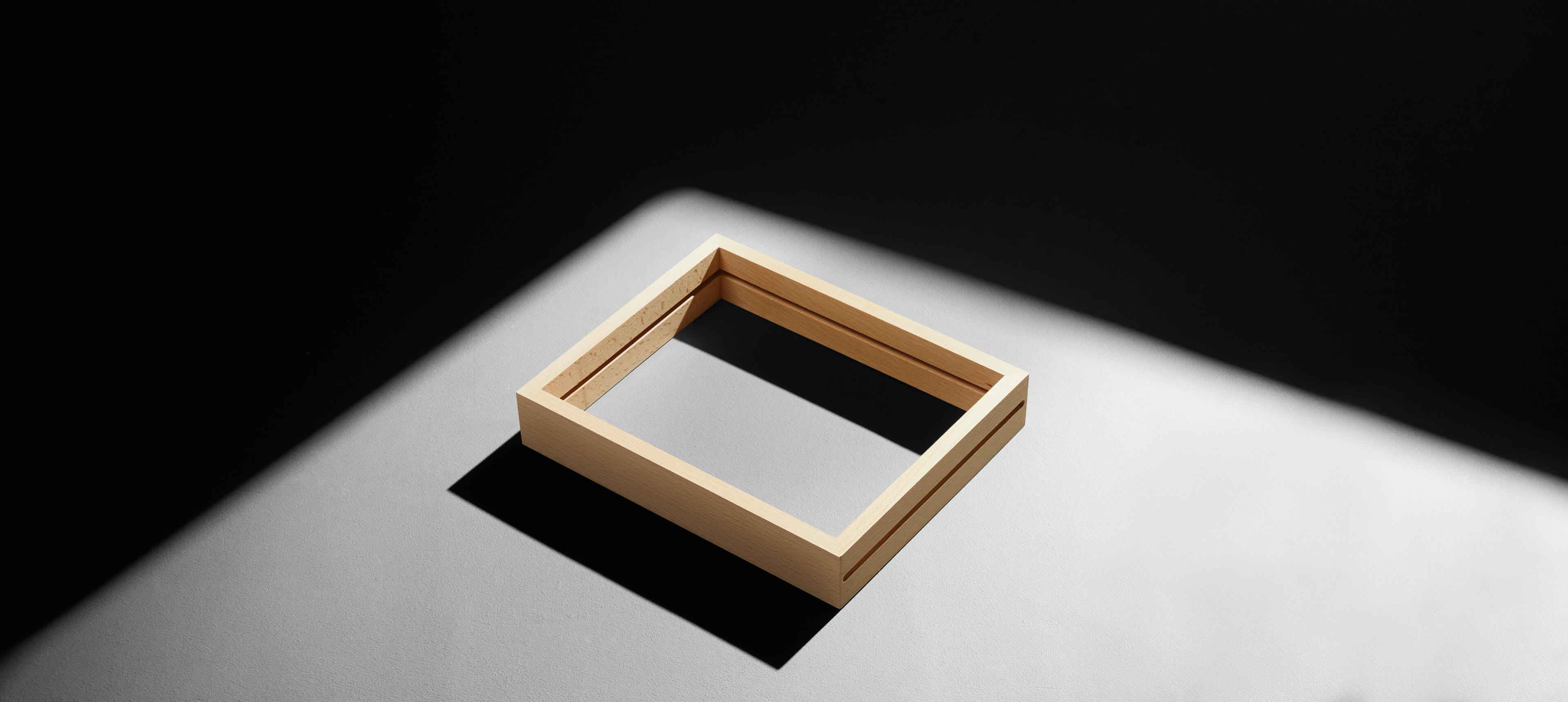 a wood frame on a white table without prints